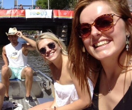 Three friends laughing in a boat.