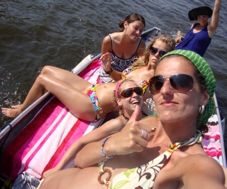 Women sunbathing and sailing on a boat Women sunbathing and sailing on a boat