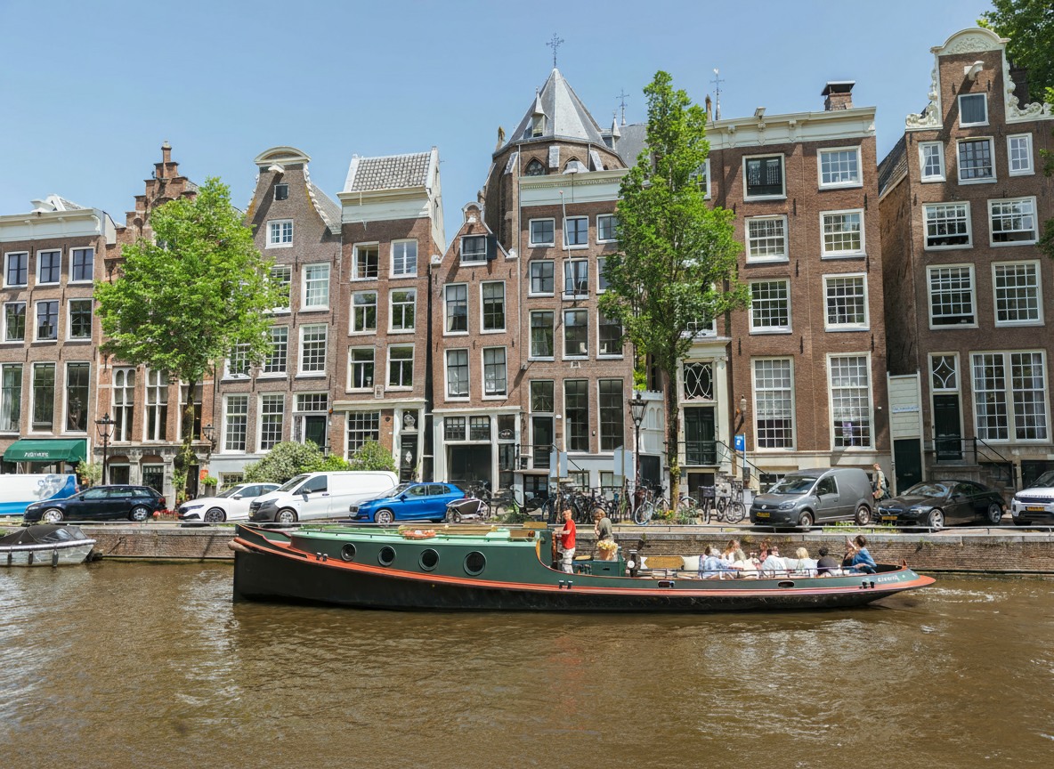 ugboat on the Amsterdam canals with a group of people.