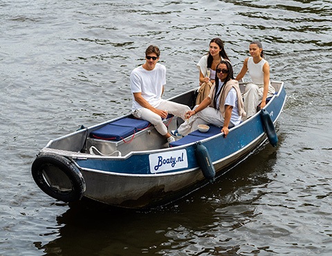 Four people are sailing on a Boaty boat.
